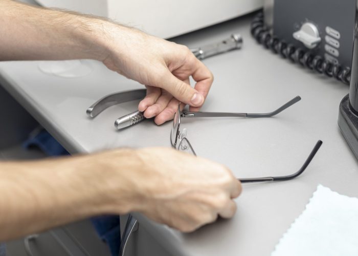 high-angle-man-putting-down-his-glasses-desk